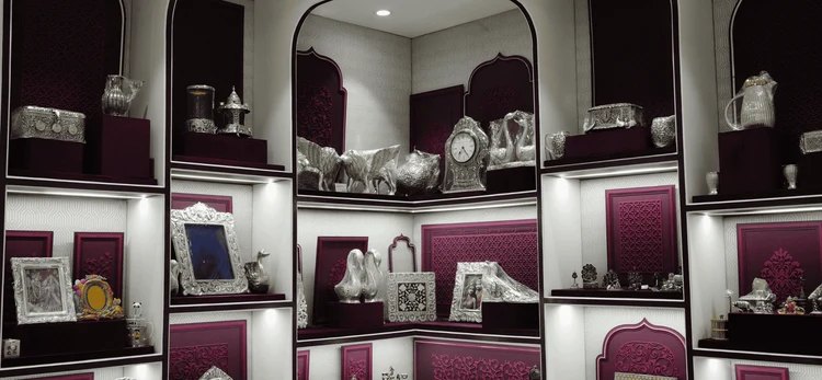 Silver artefacts displayed in arched niches at the AJB Silver Arte boutique
